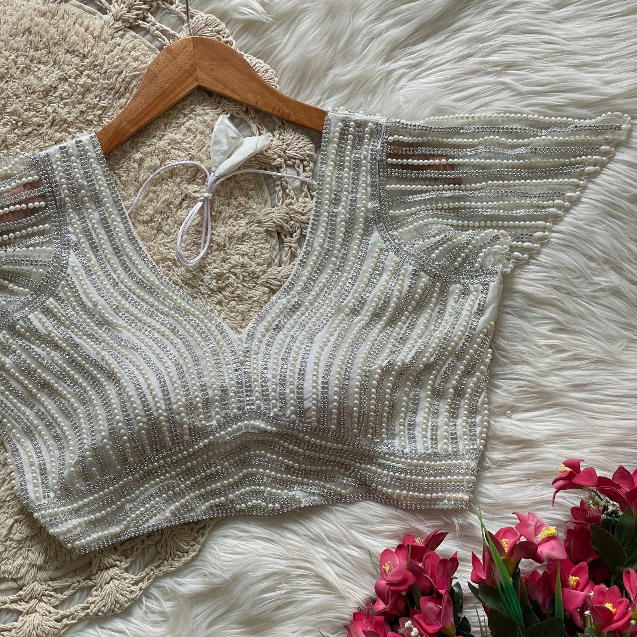 Presenting beautiful handcrafted pearl work in all over front and back of the blouse